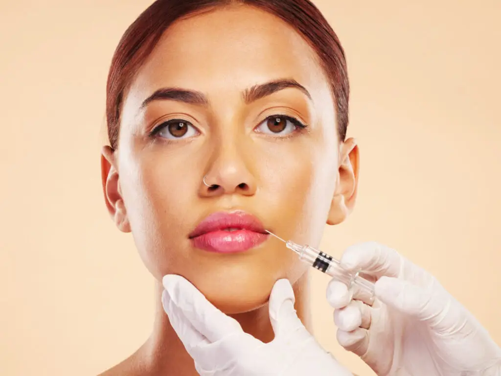 woman receiving lip filler injected by a licensed esthetician at allure med spa in el paso